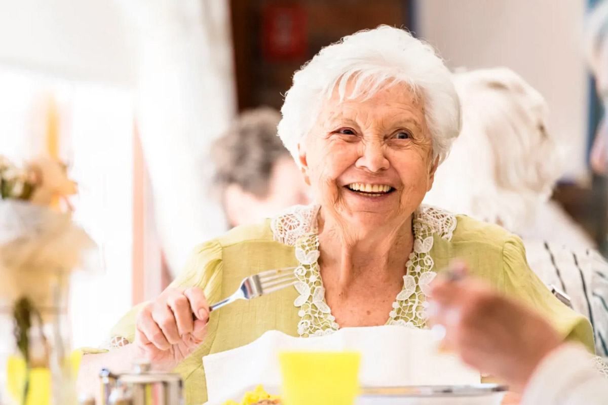 Senior-Woman-enjoying-a-meal Woman using tablet
